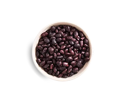 a bowl of beans on a black background